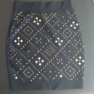 Bebe form fitting skirt XS black w/ gold